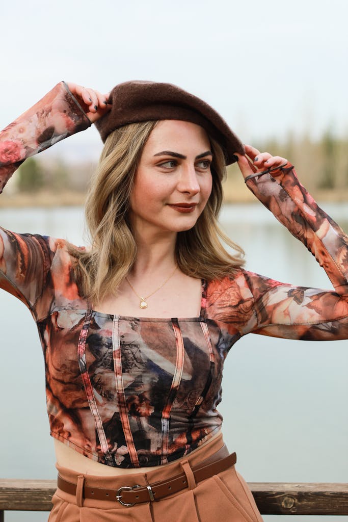A woman in a brown hat and brown pants posing for a photo